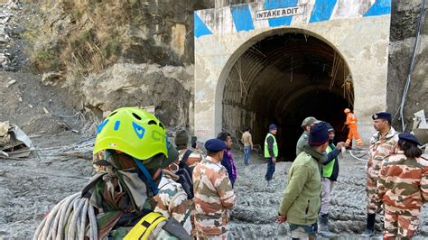 The Press Trust of India says rescuers have reached workers trapped in a collapsed mountain tunnel, have pulled one out
